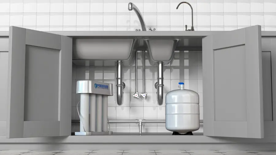PureGuard Quality Water Systems reverse osmosis (RO) drinking water filtration system installed under a kitchen sink with open cabinets, filter unit, storage tank, and dedicated faucet