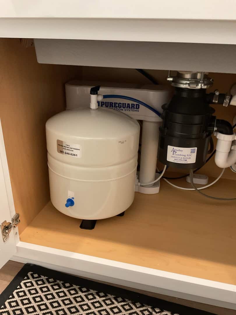 PureGuard reverse osmosis system and storage tank installed under a kitchen sink in Katy TX