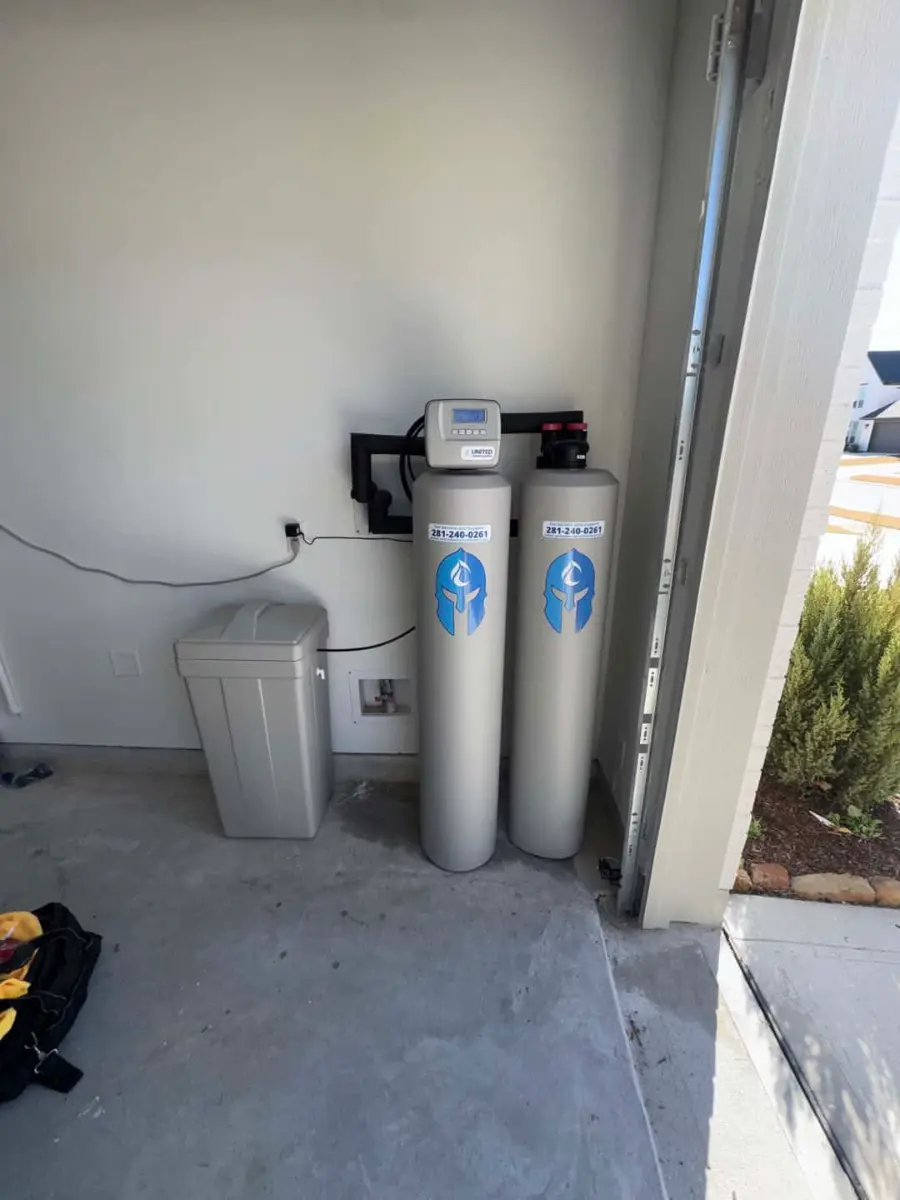 Twin-tank whole-home water softener and filtration system installed in a garage by United Water Softeners