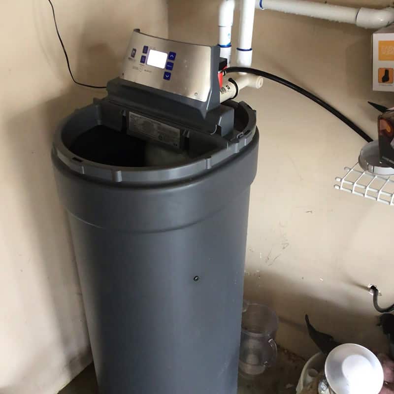Water softener control head and brine tank opened for service in a Houston-area home