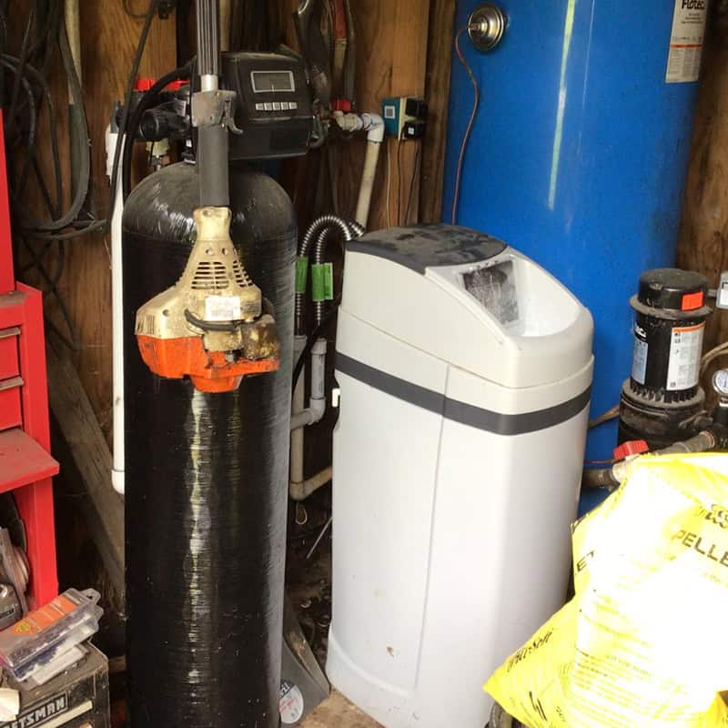 Whole-home water filter media and backwash valve being serviced by United Water Softeners