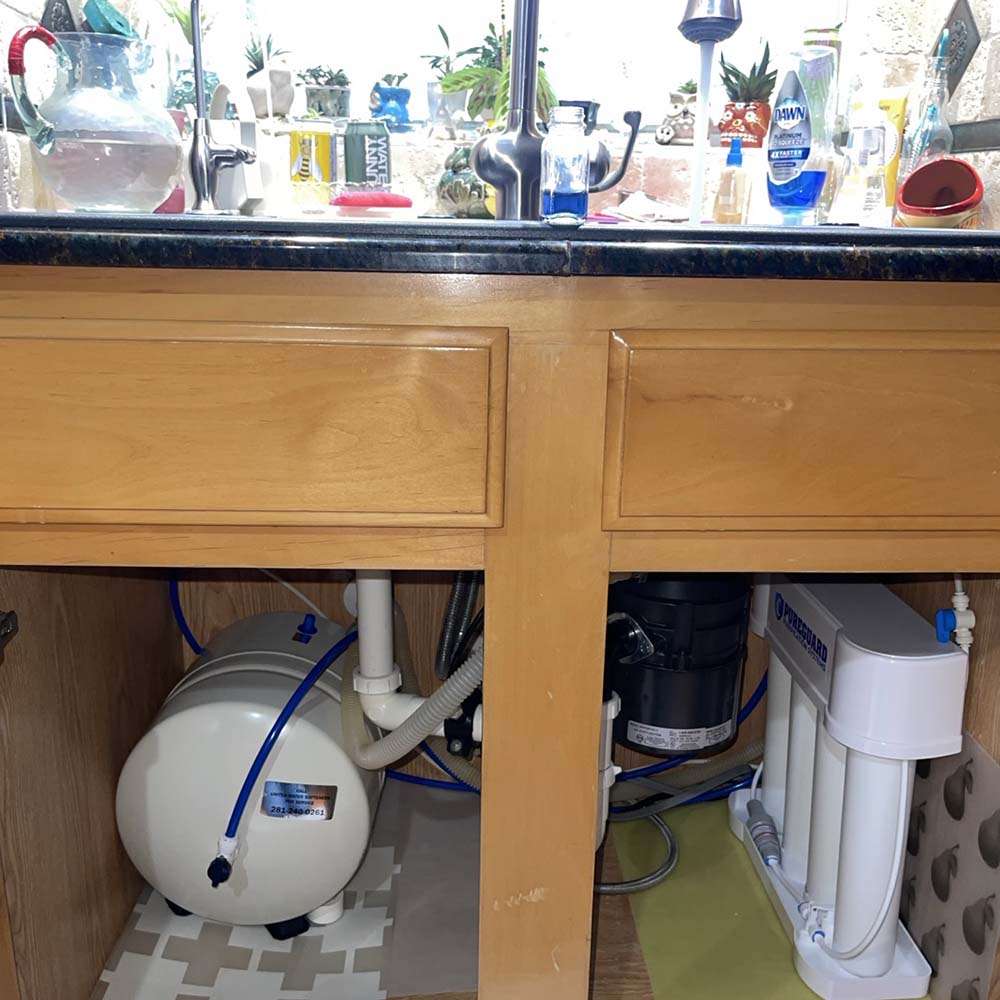 Premium reverse osmosis (RO) drinking water system with custom chrome faucet professionally installed under the kitchen sink in Cypress, Texas by United Water Softeners – Houston’s #1 rated water company.Title: