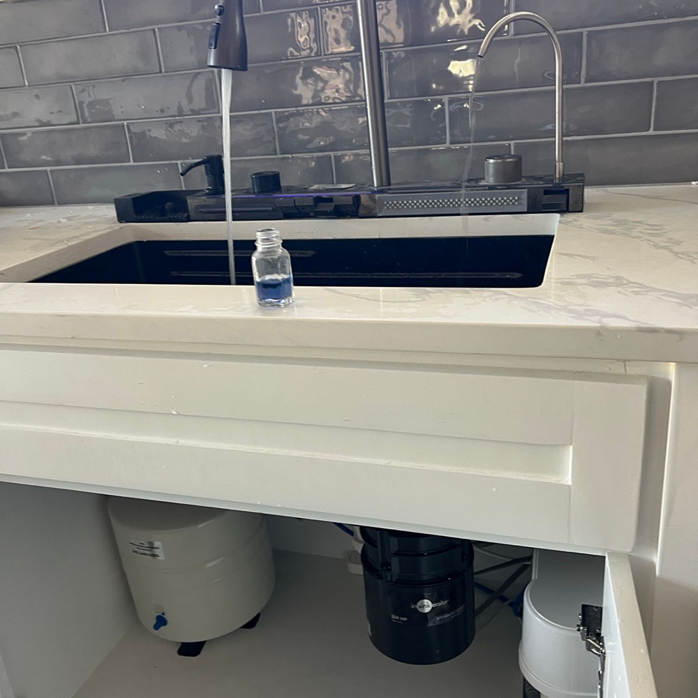 reverse osmosis drinking water system with custom chrome faucet professionally installed under the kitchen sink in Montgomery, Texas by United Water Softeners – Houston’s #1 rated water company.