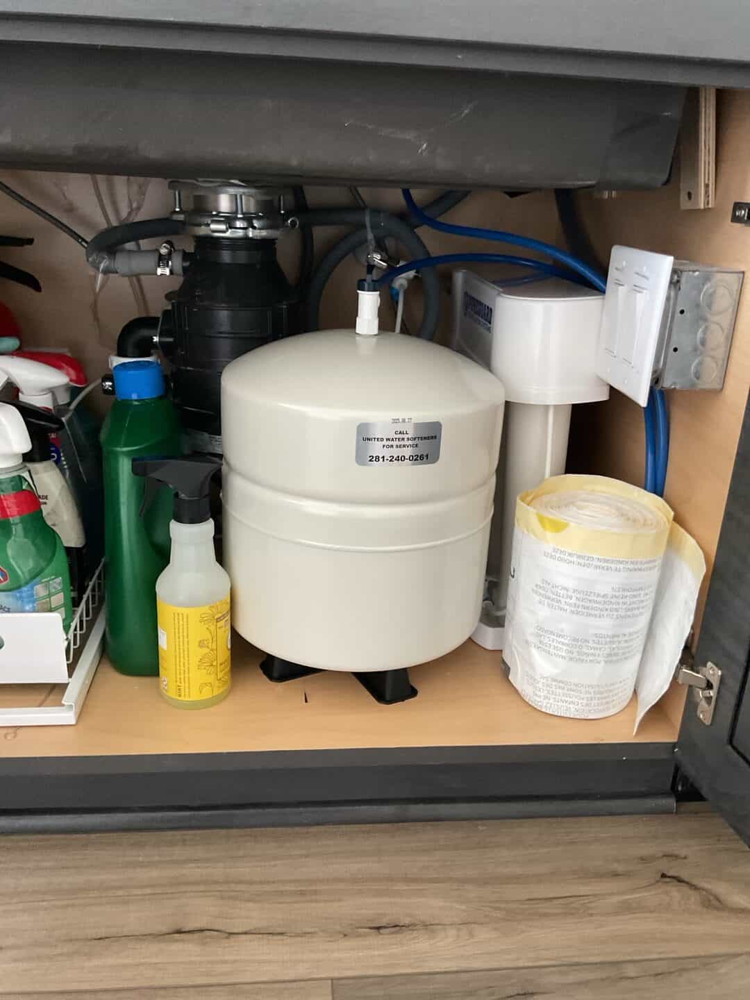 PureGuard reverse osmosis drinking water system with storage tank installed under a kitchen sink in Cypress TX 77433